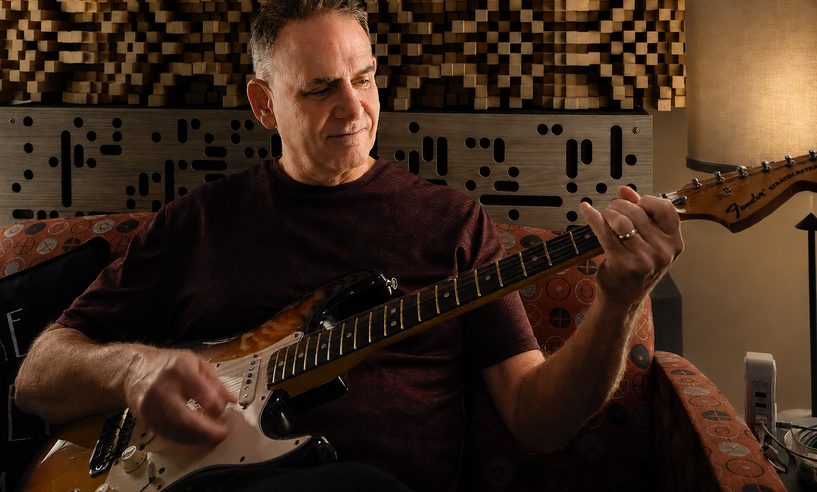 Portrait of Larry Mohl, founder, songwriter and executive producer of Third Space Music, holding a guitar